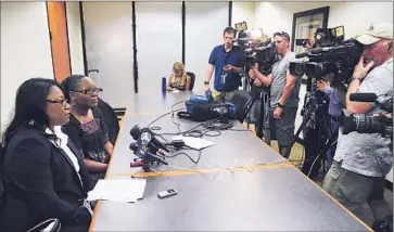  ?? Mark Boster Los Angeles Times ?? ATTORNEY CAREE HARPER , left, announces the $1.5-million settlement of a lawsuit by Marlene Pinnock. Judge Otis D. Wright III jailed Harper for two days when she refused to answer his questions.