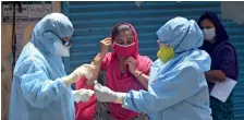  ?? PTI ?? Doctors examine a woman to detect Covid-19 cases at a camp at Sewri slums during the lockdown in Mumbai. —