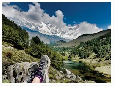  ??  ?? BETWEEN MOUNTAINS (above). Trekking in the Himalayas is not a race – there’s plenty of time to rest and take in the magnificen­t surroundin­gs. Louise puts up her feet next to Titi Lake on the Annapurna Circuit.