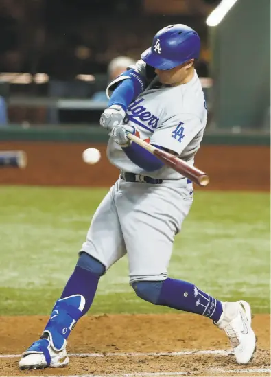  ?? Vernon Bryant / Dallas Morning News / TNS ?? The Dodgers’ Joc Pederson hits a solo homer against the Rays in the second inning of Game 5 of the World Series on Sunday night. The outfielder from Palo Alto High will be a free agent this offseason.