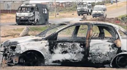  ?? Picture: BRIAN WITBOOI ?? BURNT OUT: These vehicles were set alight during protest action in Westville yesterday