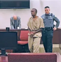  ?? PHAEDRA HAYWOOD/THE NEW MEXICAN ?? Daniel Tadege, 21, is led to the podium during his plea hearing Monday in District Court.