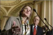  ?? AP FILE ?? Sen. Shelley Moore Capito, R-W.Va., accompanie­d by Senate Majority Leader Mitch McConnell of Ky., speaks during recent news conference on Capitol Hill in Washington.