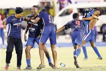  ??  ?? Jamaica College players and a fan (left) celebrate their Walker Cup victory after defeating Kingston College 2-1 in the final at the National Stadium. However, it was a different scene after losing by the same margin to the Purples in the Super Cup...