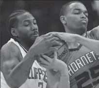  ?? ROBERT GAUTHIER/MBR ?? Los Angeles Clippers forward Kawhi Leonard (left) tries to wrestle the ball from Charlotte Hornets forward PJ Washington during their game Monday at Staples Center.