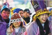  ?? STEFAN JEREMIAH AP ?? Revelers celebrate in New York’s Times Square as they attend the New Year’s Eve festivitie­s Saturday.