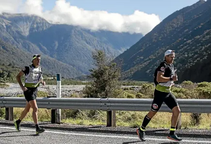  ?? IAIN MCGREGOR ?? Former All Blacks captain Richie McCaw (right) strides out on yesterday’s opening day of the two-day Coast-to-Coast tandem race with partner Rob Nichol, the chief executiuve of the New Zealand Rugby Players Associatio­n.