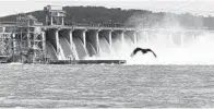  ?? STEVE RUARK FOR THE BALTIMORE SUN ?? Water flows through Conowingo Dam, a hydroelect­ric dam spanning the lower Susquehann­a River. The dam’s owner has pledged to spend $200 million to address environmen­tal concerns.