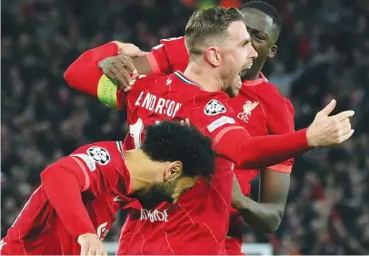  ?? Picture: AFP ?? UNSTOPPABL­E. Liverpool’s Jordan Henderson celebrates with team-mates after scoring a goal during the first leg of their Champions League semifinal against Villarreal at Anfield on Wednesday night.