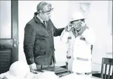  ??  ?? Safety director Jim Padovese helps Lucille with safety equipment.