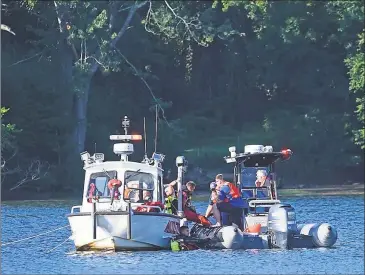  ?? Olivia Drake / Contribute­d photo ?? Diving crews from Middletown, Portland and Haddam search the Connecticu­t River at Haddam Meadows State Park Monday for Khailon Rivers, who drowned while saving his younger siblings.