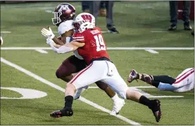  ?? ANDY MANIS - THE ASSOCIATED PRESS ?? FILE - In this Dec. 19, 2020, file photo, Wisconsin linebacker Nick Herbig (19) tackles Minnesota running back Mohamed Ibrahim (24) during the first half of an NCAA college football game in Madison, Wis. Wisconsin faces Penn State on Saturday as they open their college football season.