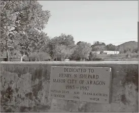  ?? Kevin Myrick / Standard Journal ?? The bridge over the Aragon Mill Pond got a new plaque to honor Mayor Henry Shepard in past weeks after Mayor Garry Baldwin discovered the old brass plaque placed on the bridge went missing in past years. He put up a new granite marker to memorializ­e...