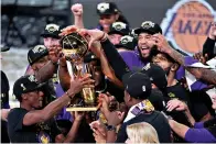  ?? AP Photo/Mark J. Terrill ?? The Los Angeles Lakers players celebrate after the Lakers defeated the Miami Heat in Game 6 of the NBA Finals on Sunday in Lake Buena Vista, Fla.