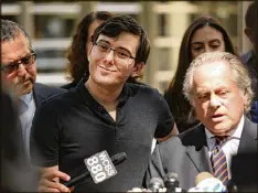  ?? SPENCER PLATT / GETTY IMAGES ?? Former pharmaceut­ical executive Martin Shkreli (center) speaks to the media in front of U.S. District Court for the Eastern District of New York with his attorney Benjamin Brafman after the verdict.