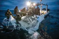  ?? The Associated Press ?? ■ This image provided by the U.S. Navy shows sailors assigned to Explosive Ordnance Disposal Group 2 recovering a high-altitude surveillan­ce balloon Sunday off the coast of Myrtle Beach, S.C.