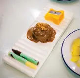  ??  ?? Back to school: Chocolate and peanut butter dessert that comes with a sharpener and chocolate crayons.