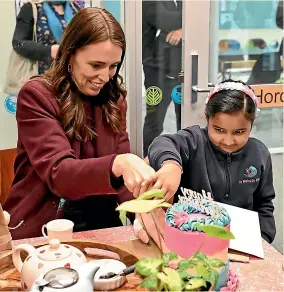  ?? KAI SCHWOERER/STUFF ?? Te Ro¯ hutu Whio pupil Aavya Pandya’s sixth birthday yesterday included a birthday cake, cut by Prime Minister Jacinda Ardern.