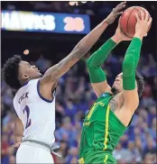  ?? Orlin Wagner / The Associated Press ?? Oregon’s Dillon Brooks (right) shoots over Kansas’ Lagerald Vick during the first half of Saturday’s game.