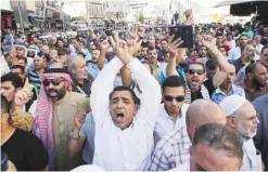  ?? — AFP ?? AMMAN: Protestors chant slogans in the Jordanian capital yesterday during a demonstrat­ion against the closure of the Al-Aqsa Mosque compound in Jerusalem.