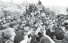  ??  ?? Police officers speak to the media outside the headquarte­rs of Honduras’ elite police force, after an agreement with the government not to crack down on demonstrat­ors in the marches over a contested presidenti­al election, according to local media, in...