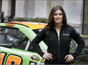  ?? RICHARD DREW — THE ASSOCIATED PRESS FILE ?? In this file photo, face car driver Danica Patrick poses with her car in front of the New York Stock Exchange before the GoDaddy IPO. GoDaddy tells The Associated Press it is partnering with Patrick as she closes her career with the Daytona 500 and the...