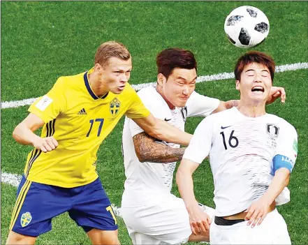  ??  ?? Sweden’s midfielder Viktor Claesson (left), vies for the header with South Korea’s defender Jang Hyun-soo (center), and South Korea’s midfielder Ki Sung-yueng during the Russia 2018 World Cup Group F football match between Sweden and South Korea at the...