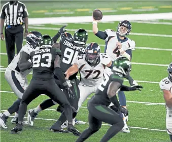  ?? Andy Cross, The Denver Post ?? Broncos quarterbac­k Brett Rypien throws a long pass for a completion to wide receiver Tim Patrick in the fourth quarter against the New York Jets on Thursday night.