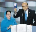  ??  ?? Khizr Khan holds a copy of the U.S. constituti­on, with his wife Ghazala Khan, at the Democratic National Convention in Philadelph­ia in July 2016.