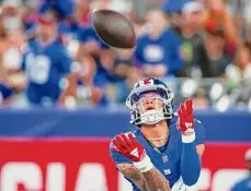  ?? ?? John Munson/Associated Press Giants receiver Jalin Hyatt catches a touchdown pass during the first half of a preseason game against the Panthers on Friday night in East Rutherford, N.J.