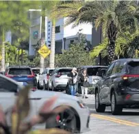  ?? ?? Patrons walk along with traffic at popular Uptown Boca shopping plaza in West Boca on Thursday.