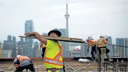  ?? POSTMEDIA NETWORK FILES ?? Workers are seen at a constructi­on site in Toronto, above. Avery Shenfeld, chief economist at CIBC World Markets, says even though real GDP is approachin­g an 18-year high, we’re not as rich as we think.