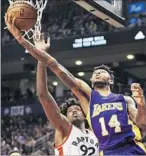  ?? Frank Gunn Canadian Press ?? BRANDON INGRAM goes around Lucas Nogueira to score two of his team-high 17 points. The Lakers shot 34.4% for the game.