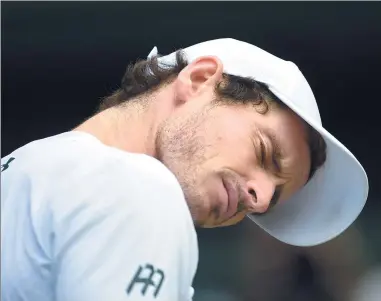  ?? TOBY MELVILLE / REUTERS ?? Defending champion Andy Murray reacts to a challenge ruling during his 3-6, 6-4, 6-7 (4), 6-1, 6-1 Wimbledon quarterfin­al loss to Sam Querrey on Wednesday.