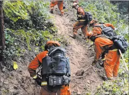  ?? Marcio Jose Sanchez The Associated Press ?? A California Department of Correction­s crew builds a containmen­t line Saturday along Highway 9 against the CZU Lightning Complex fire in Boulder Creek, Calif.