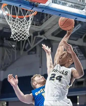  ?? Steph Chambers/Post-Gazette photos ?? Vincentian’s Angelo Reeves dunks against Cornell in the WPIAL Class 1A championsh­ip game Thursday at Petersen Events Center. Vincentian won, 63-51.