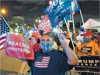  ?? WILFREDO LEE/AP ?? Supporters of President Donald Trump chant and wave flags during Election Night in Miami’s Little Havana.