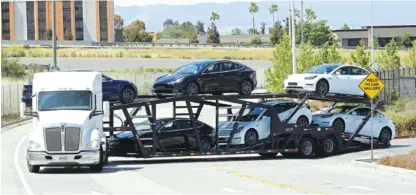  ?? AP PHOTO/BEN MARGOT ?? A truck hauling new Tesla vehicles leaves the factory Monday in Fremont, Calif.