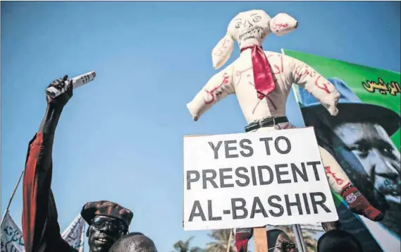  ?? Photo: Zohra Bensemra/Reuters ?? Support for dictator: Supporters of Sudanese President Omar al-Bashir hold an effigy of Luis Moreno Ocampo, a prosecutor of the Internatio­nal Criminal Court. The ANC claims the Rome Statute is sometimes in conflict with South Africa’s foreign policy.