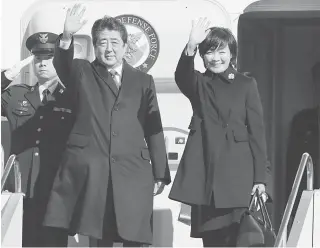  ?? AFP PHOTO ?? HAWK ON BOARD Japan’s Prime Minister Shinzo Abe (center) and his wife Akie wave as they leave Tokyo’s Haneda airport on Friday.