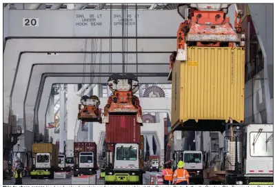  ?? (AP/Stephen B. Morton) ?? Ship-to-shore cranes load and unload containers from a cargo ship at the Georgia Ports Authority Garden City Terminal on Dec. 17, 2021, in Savannah, Ga.