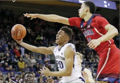  ?? ELAINE THOMPSON — THE ASSOCIATED PRESS FILE ?? Washington’s Markelle Fultz (20) looks for a shot during the second half of a game against Arizona last season in Seattle. Fultz is the biggest step in the right direction for the 76ers, but he surely won’t be the last move.