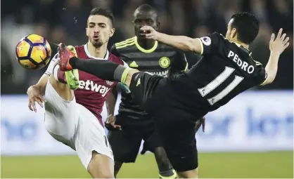  ??  ?? LONDON: West Ham’s Manuel Lanzini, left, and Chelsea’s Pedro battle for the ball during the English Premier League soccer match between West Ham and Chelsea at London Stadium, Monday. — AP