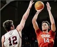  ?? Maddie Malhotra / Getty Images ?? Jesse Edwards of Syracuse shoots over Boston College’s Quinten Post during their game Saturday. Edwards finished with a career-high 27 points to help the Orange pull away. Glens Falls grad Joseph Girard III added 18 points for Syracuse.