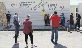  ??  ?? Přímo na hranici Zeď u uzavřeného přechodu na hranici s Libanonem ukazuje, že odtud je to mnohem blíž do Bejrútu než do Jeruzaléma. Zjevně ze všech nejraději se tu fotí izraelští Arabové.