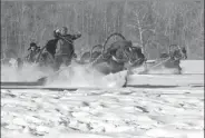  ??  ?? Ethnic Kazak people compete in a horse-drawn sleigh competitio­n.