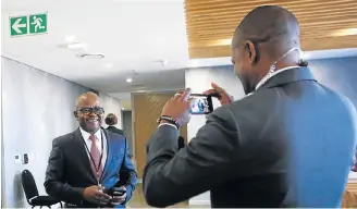  ?? Picture: MASI LOSI ?? IN SPOTLIGHT: A journalist snaps a picture of former GCIS chief Themba Maseko as he arrives at the state capture commission where he has been giving his testimony