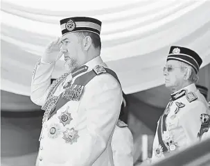  ?? — Gambar Bernama ?? TABIK DIRAJA: Sultan Muhammad V (kiri) menerima hormat diraja pada istiadat perbarisan sempena Sambutan Hari Pahlawan 2018 berlangsun­g di Dataran Pahlawan Negara semalam.