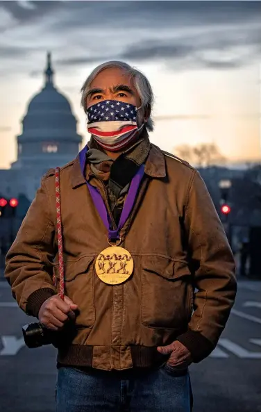  ??  ?? HEAVY MEDAL Photograph­er Nick Ut with the Medal of Arts he received from the president, a week after pro-trump supporters stormed the U.S. Capitol.