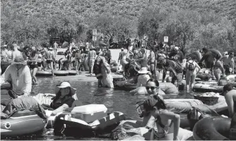  ?? REUTERS • CHENEY ORR ?? People prepare to go tubing on Salt River amid the outbreak of the coronaviru­s disease (COVID19) in Arizona.